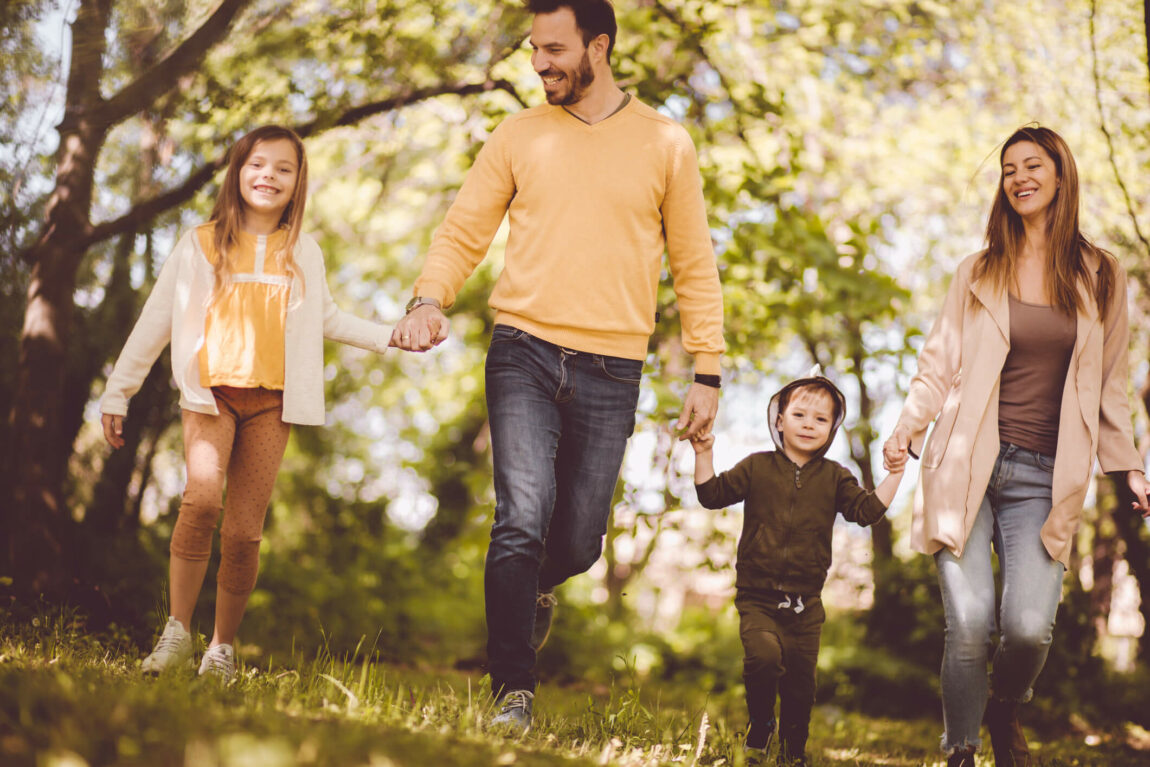 We one happy family. Parents spending time with their children outside.